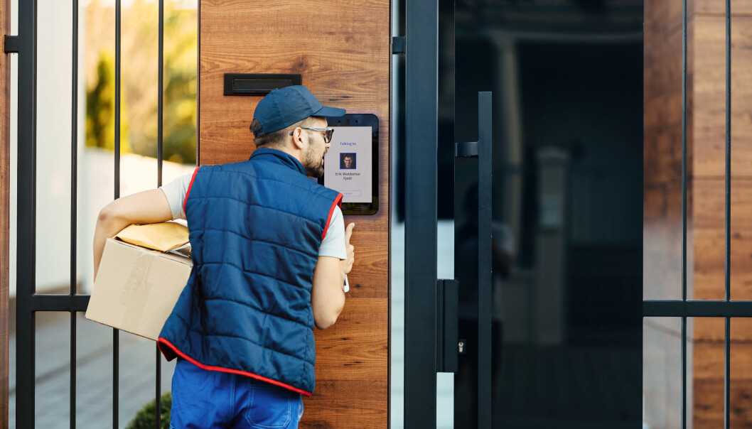 Back view of a deliverer ringing on intercom at gate of a customer's house while delivering packages. Back view of a deliverer ringing on intercom at gate of a customer's house while delivering packages.